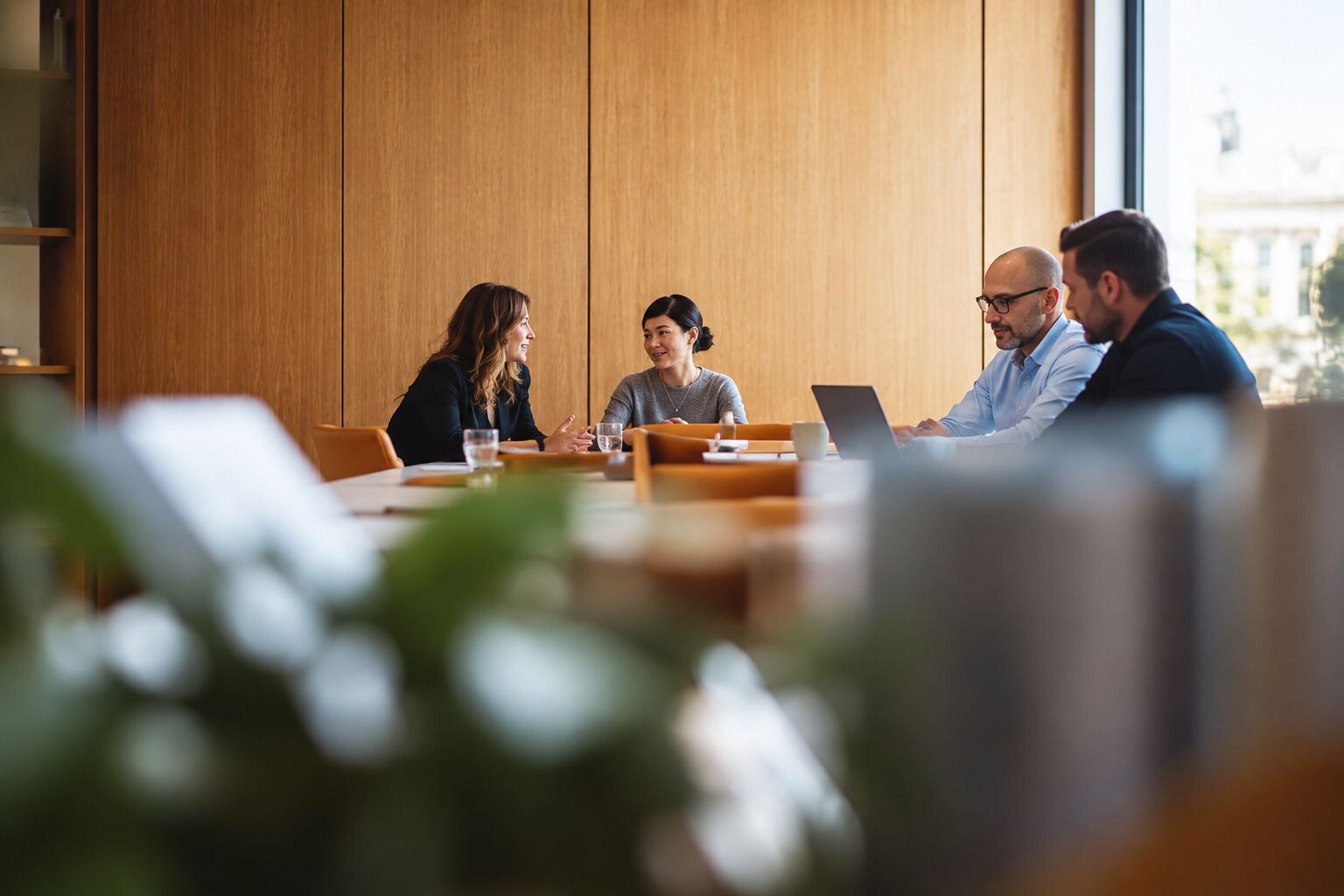A small team meeting in a warm timber-lined room