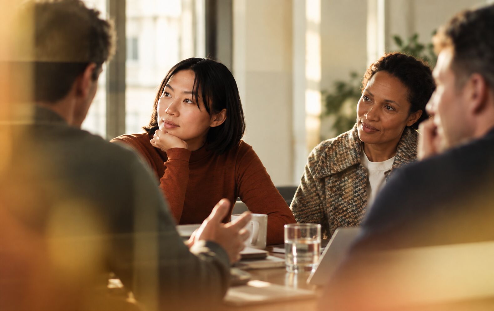 Clients listening closely around a table
